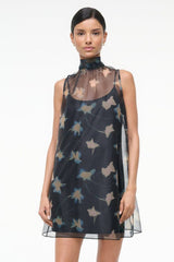 Front view of black sleeveless mini dress with high neckline and bird silhouette print