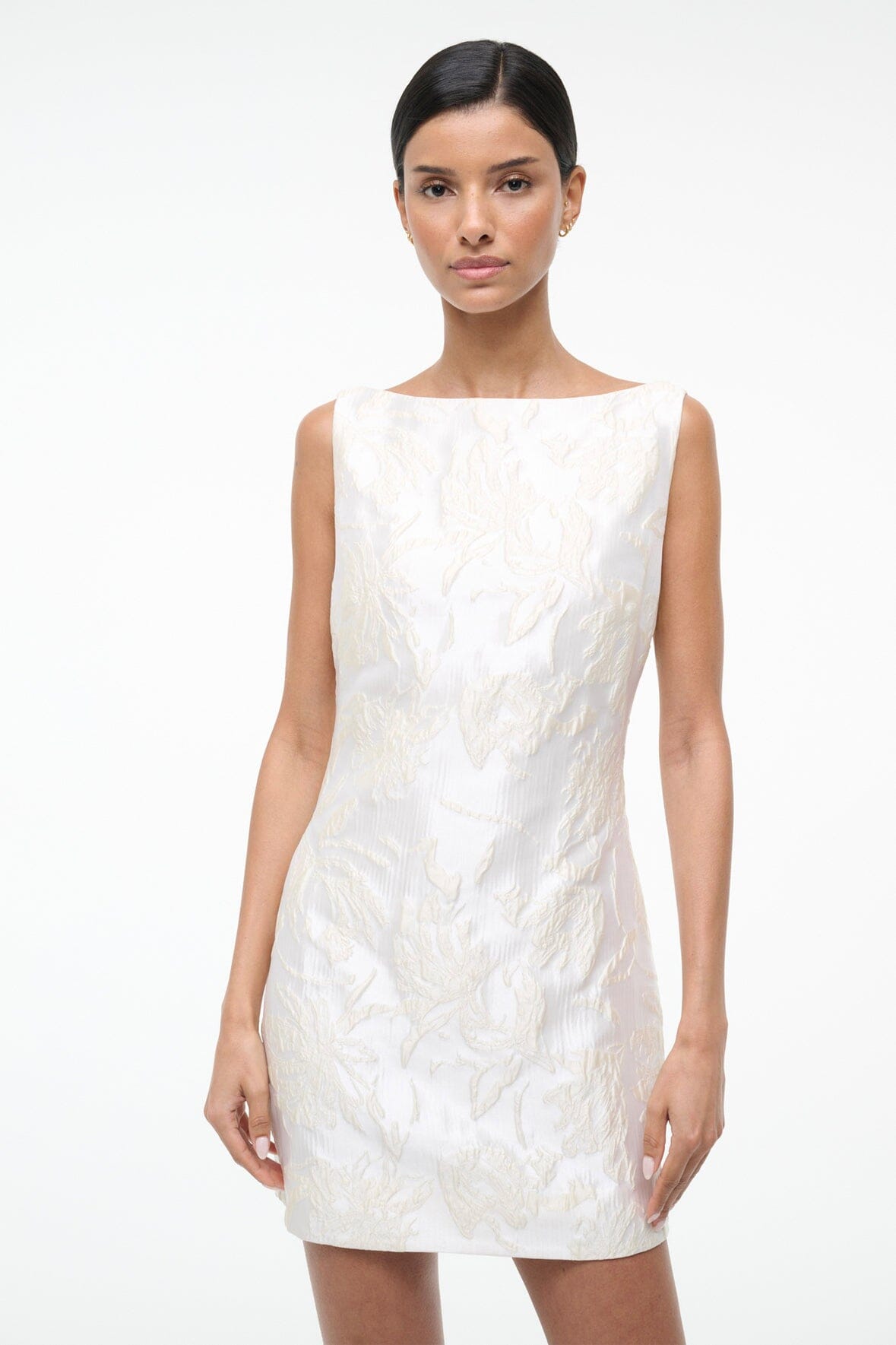 Ivory sleeveless mini dress with textured leaf print, straight hem.