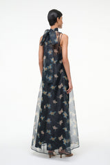 Back view maxi dress with sheer dark fabric and pale bird print, long flowing silhouette