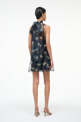 Back view of black sleeveless mini dress with high neck and bird print over sheer mesh