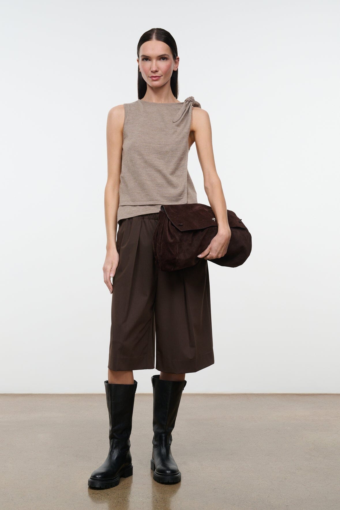 Dark brown knee-length shorts with elastic waist and loose wide fit