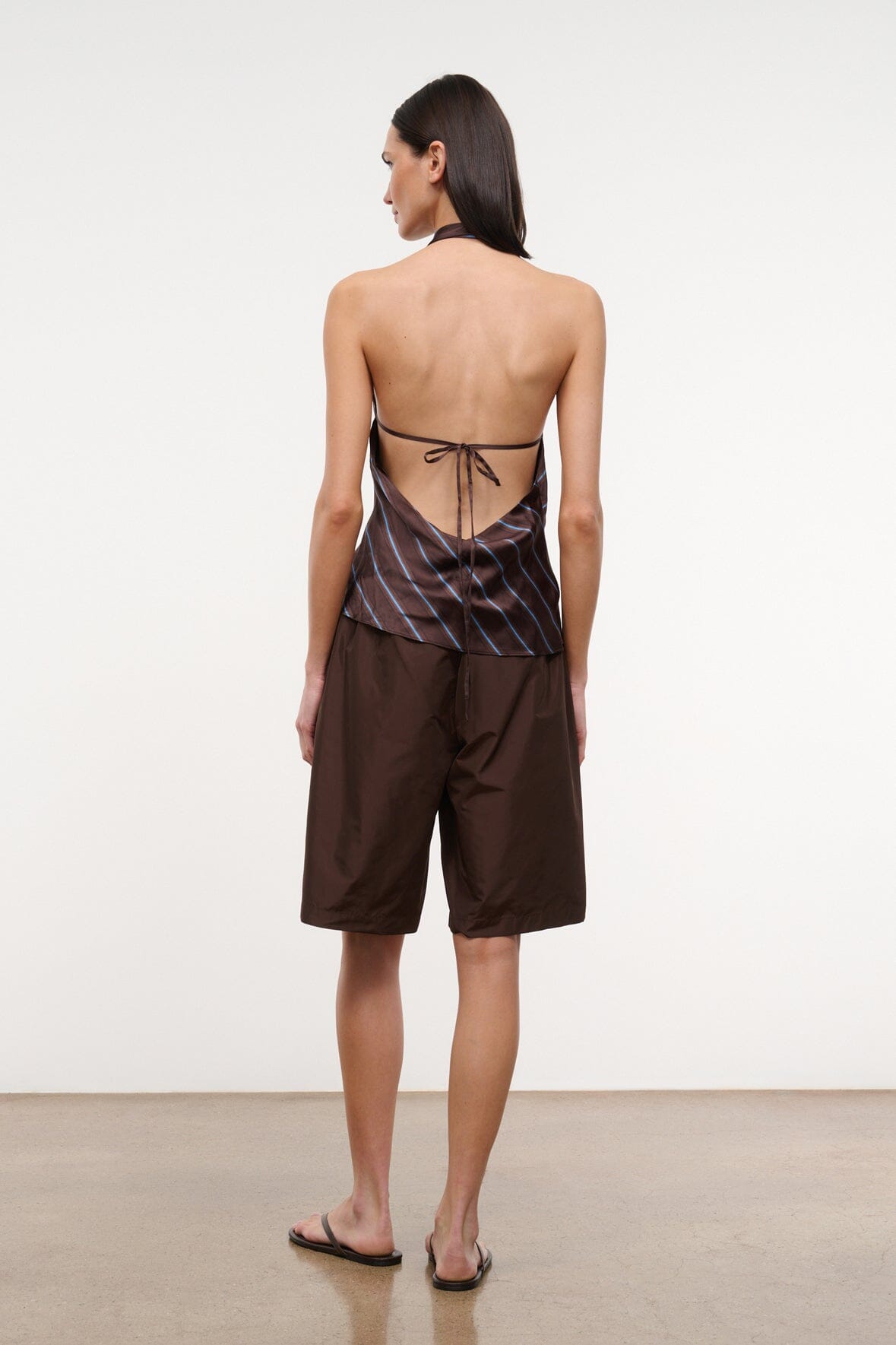 Dark brown bermuda shorts, back view, elastic waist with gathered detail