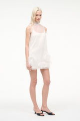White sleeveless mini dress with feather trim hem and round neckline