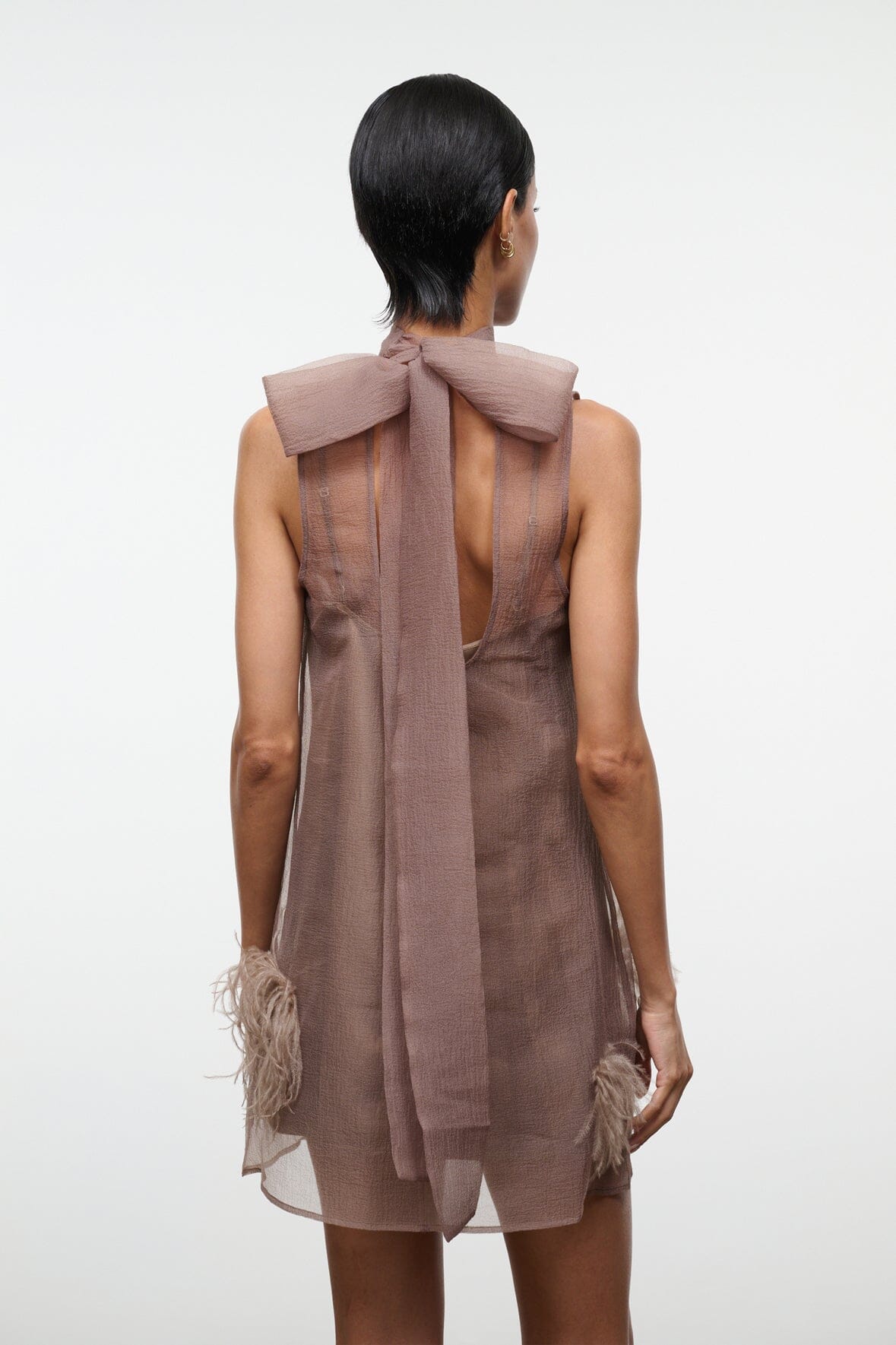 Taupe mini dress back with large bow at collar and feathered trim at hem