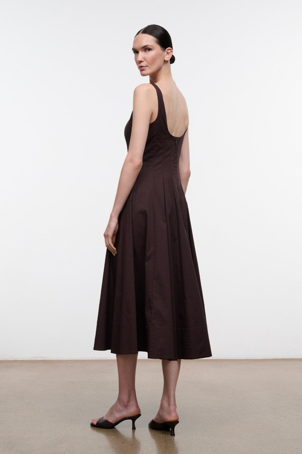 Dark brown sleeveless midi dress with sleeveless straps and flared, pleated skirt