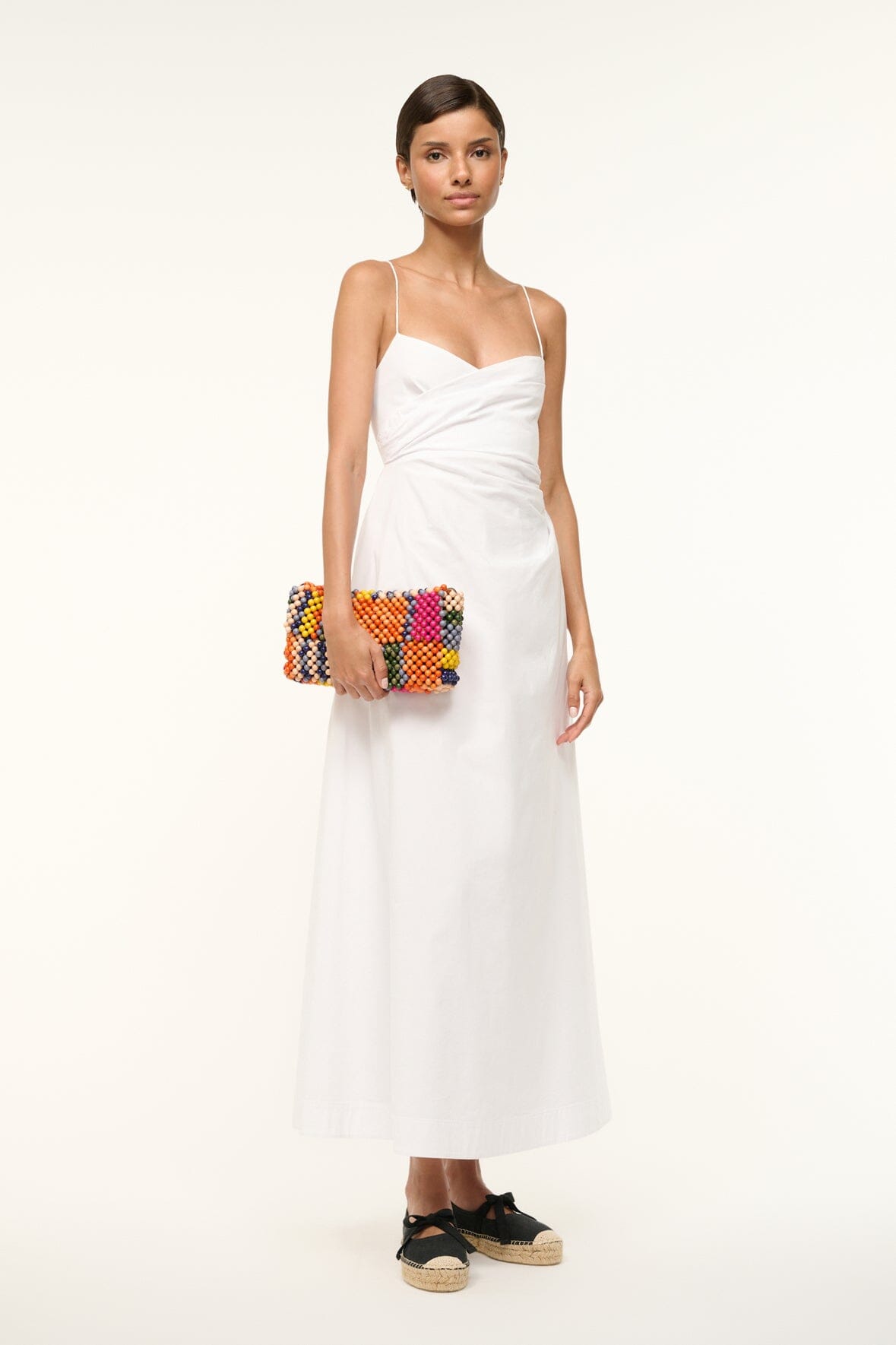 TIMMY shoulder bag in multicolor bead stripes worn by model with a white dress.