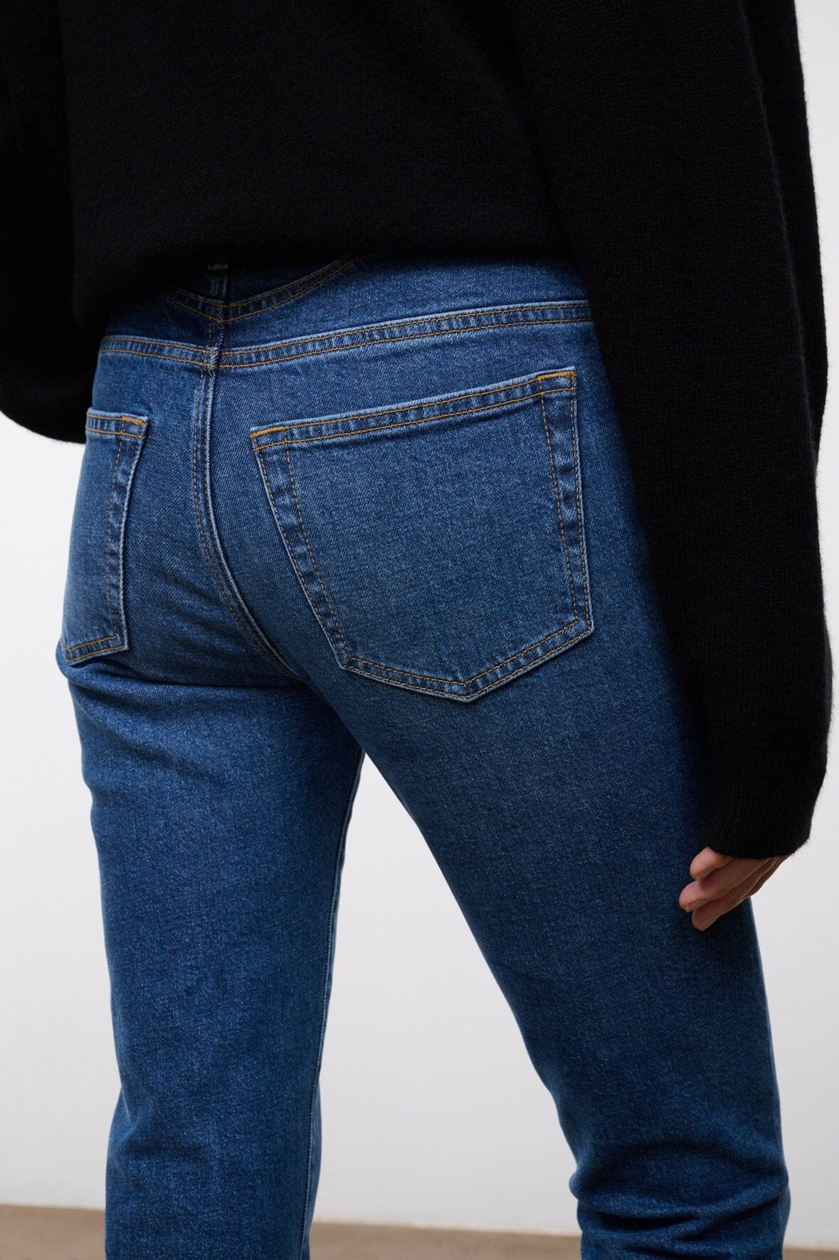 Women's stone blue stretch flare jeans, back pocket and waistband detail, cuffed hem