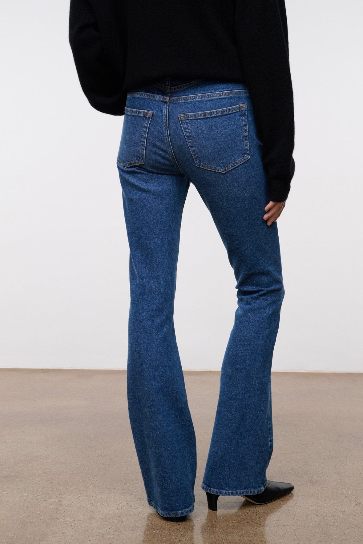 Women's stone blue stretch flare jeans with front pockets and straight-to-flare leg