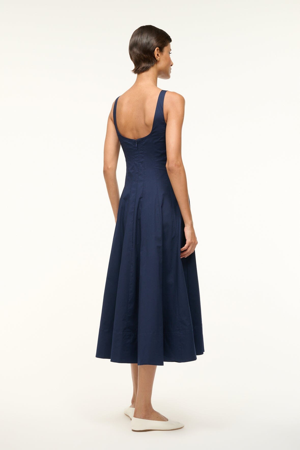 Navy sleeveless dress from back view with square neckline and flared skirt