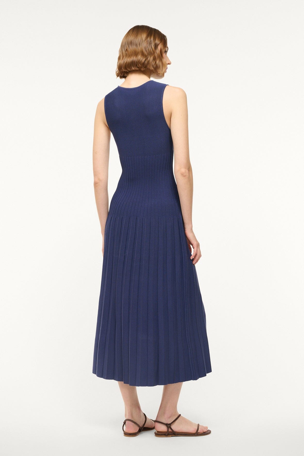 ELYSE navy sleeveless midi dress, back view with gathered pleated skirt