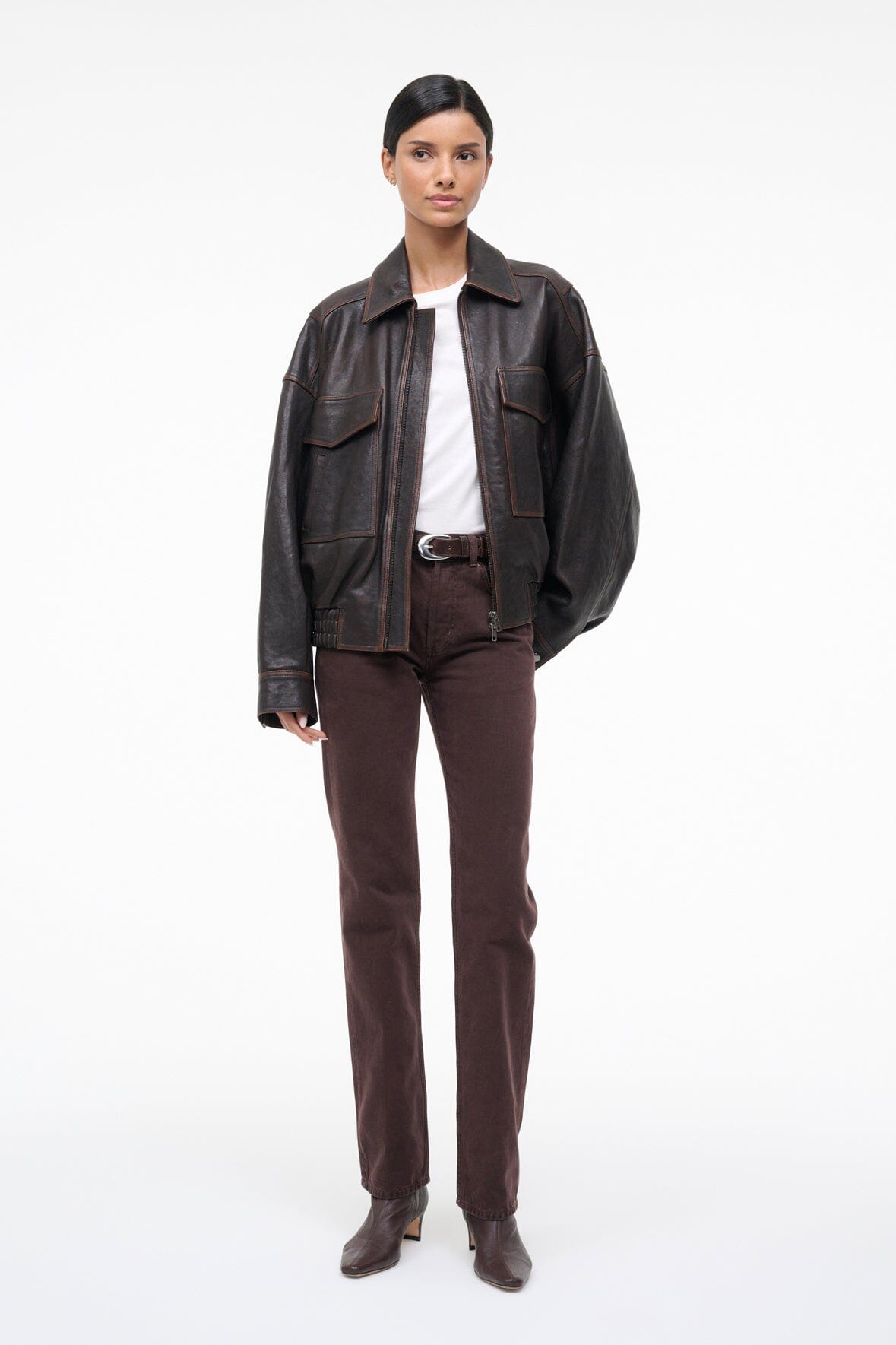 Distressed brown leather jacket with stand collar, zip front, and flap chest pockets