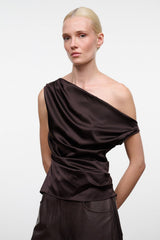 Dark brown one-shoulder silk top with diagonal neckline drape and ruched waist