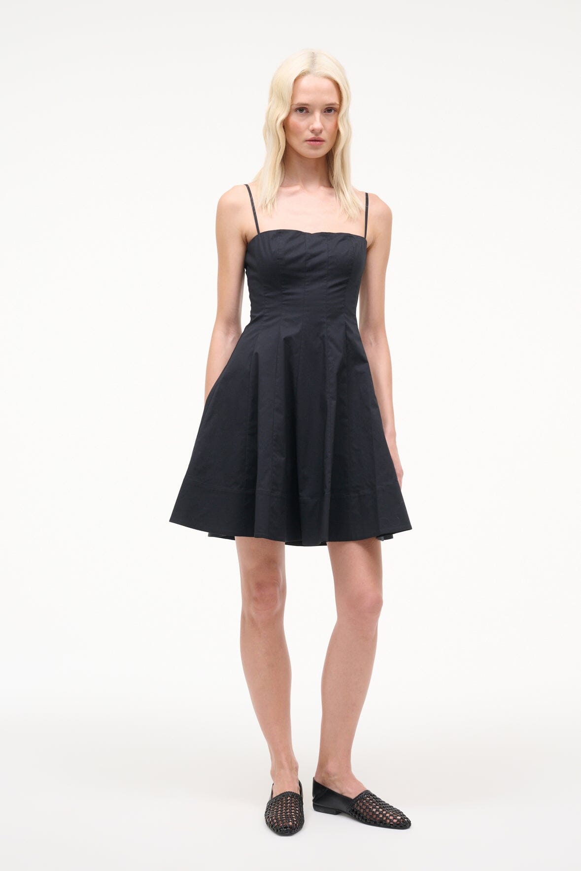 Black mini dress with spaghetti straps, square neckline, gathered skirt; full length view