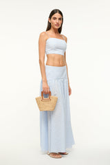 Raffia mini bucket bag in natural tan with brown handle, held by model