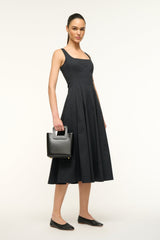 Black leather mini bag with top handle, structured shape, and stitched detailing