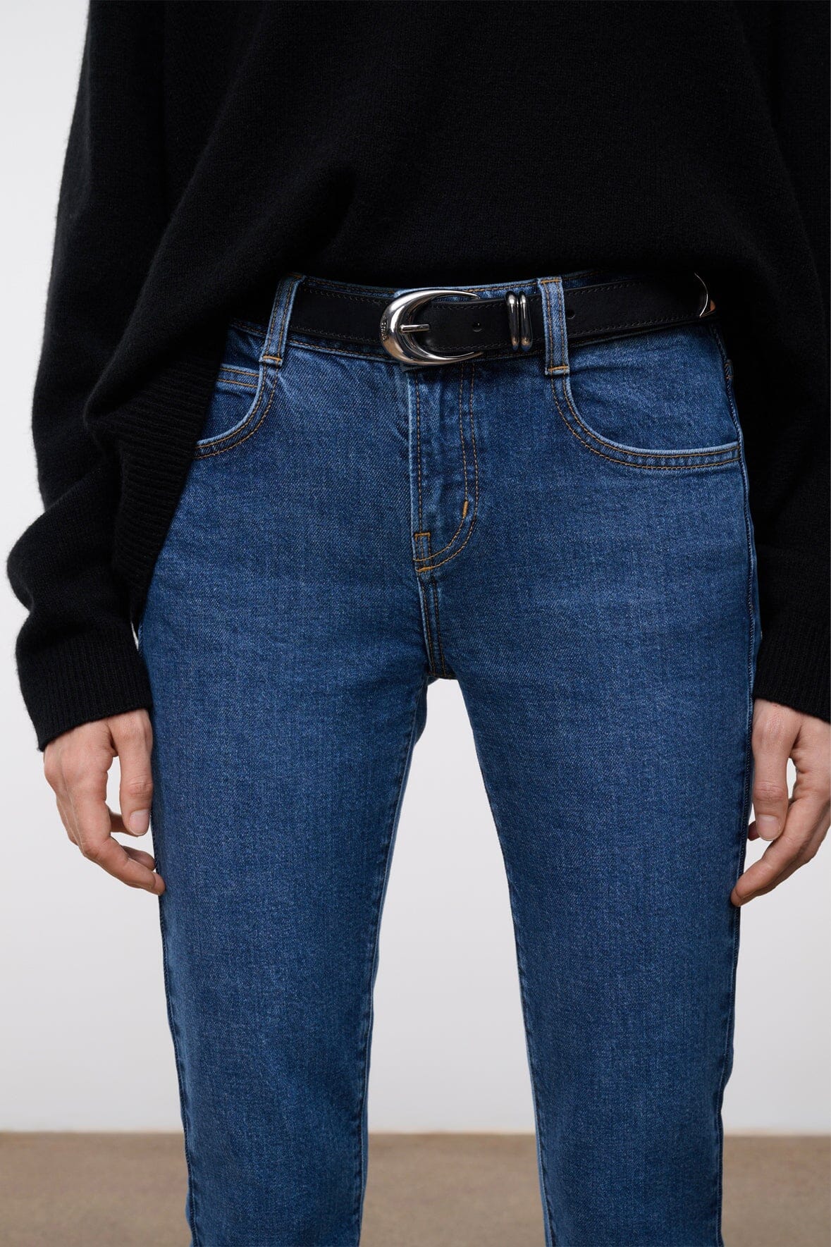 MOON METAL keeper belt worn with blue jeans, black strap and silver buckle