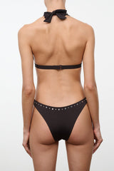 Black bikini bottom, back view, with studded waistband and narrow coverage
