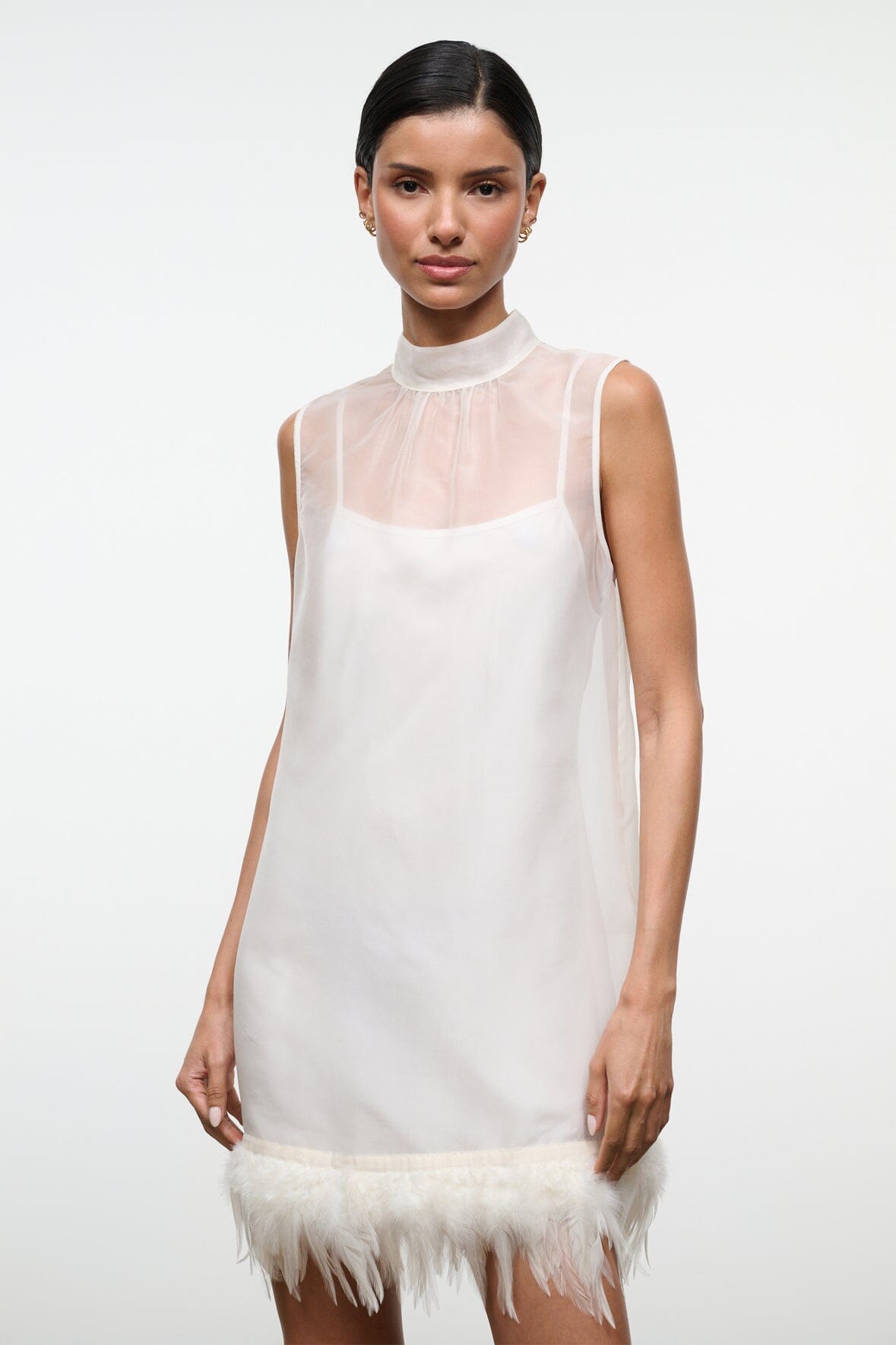 Ivory mini dress with high neck sheer overlay and feather trim
