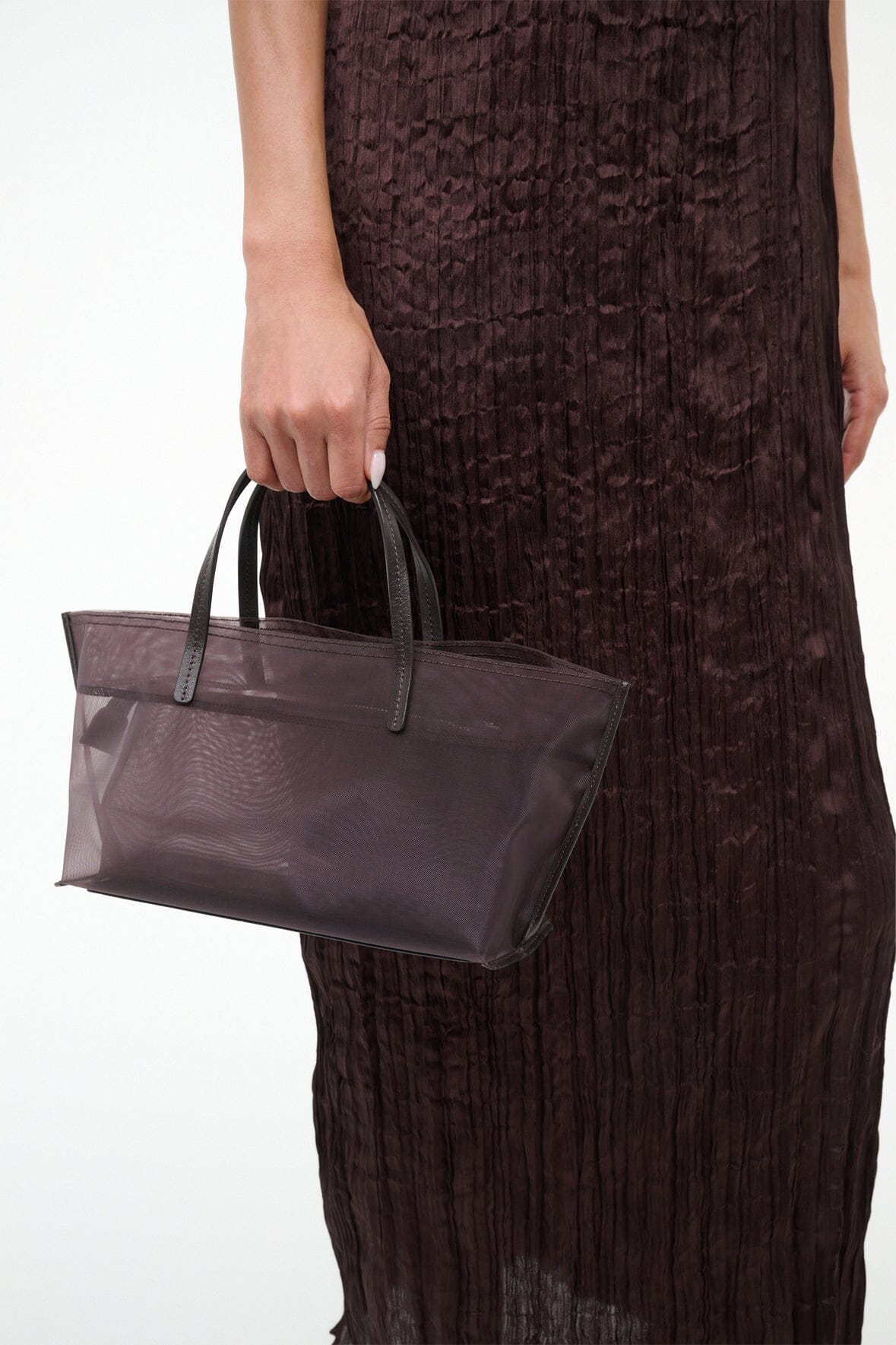 Mini mesh tote held by handles, espresso-brown sheer mesh