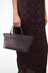 Mini mesh tote held by handles, espresso-brown sheer mesh