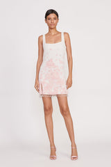Ivory mini sundress with pink floral toile print, sleeveless square neckline, tassel hem