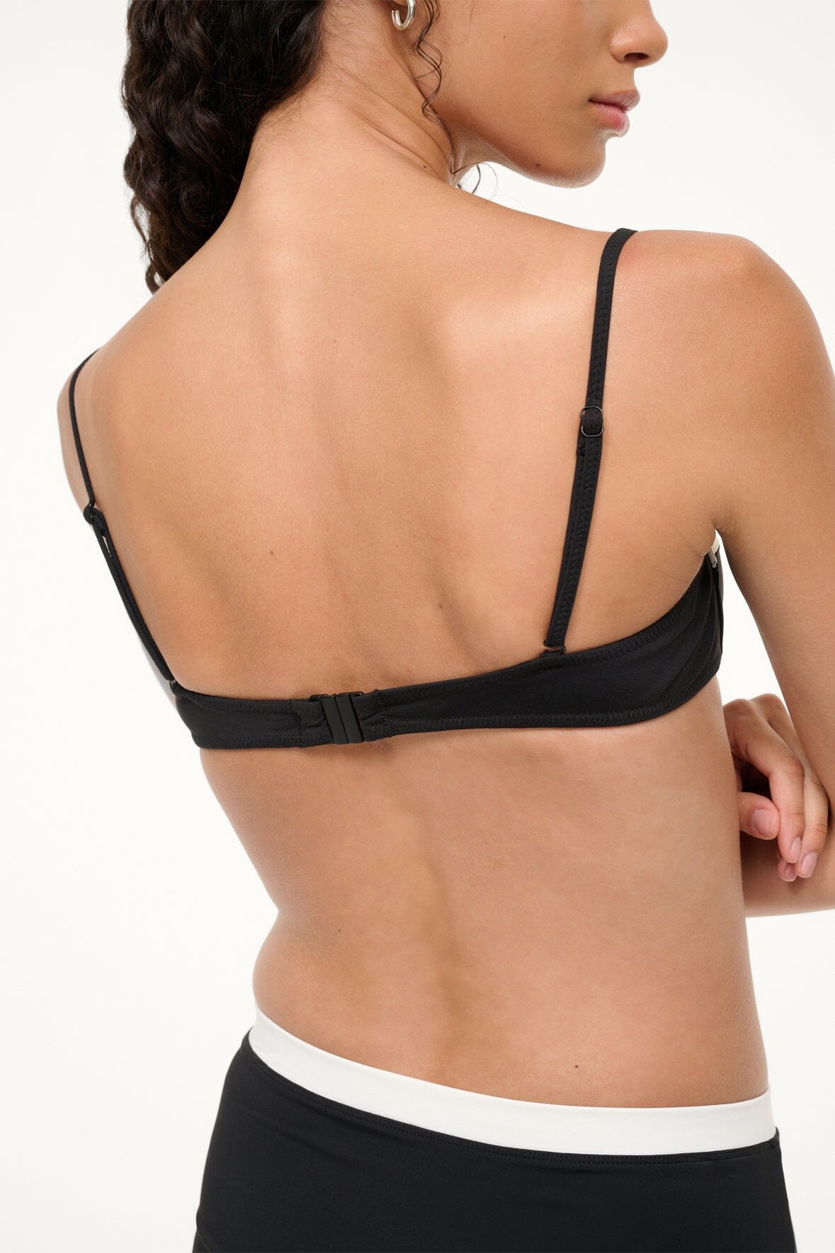 Black bikini top back with thin straps and adjustable band, white underband