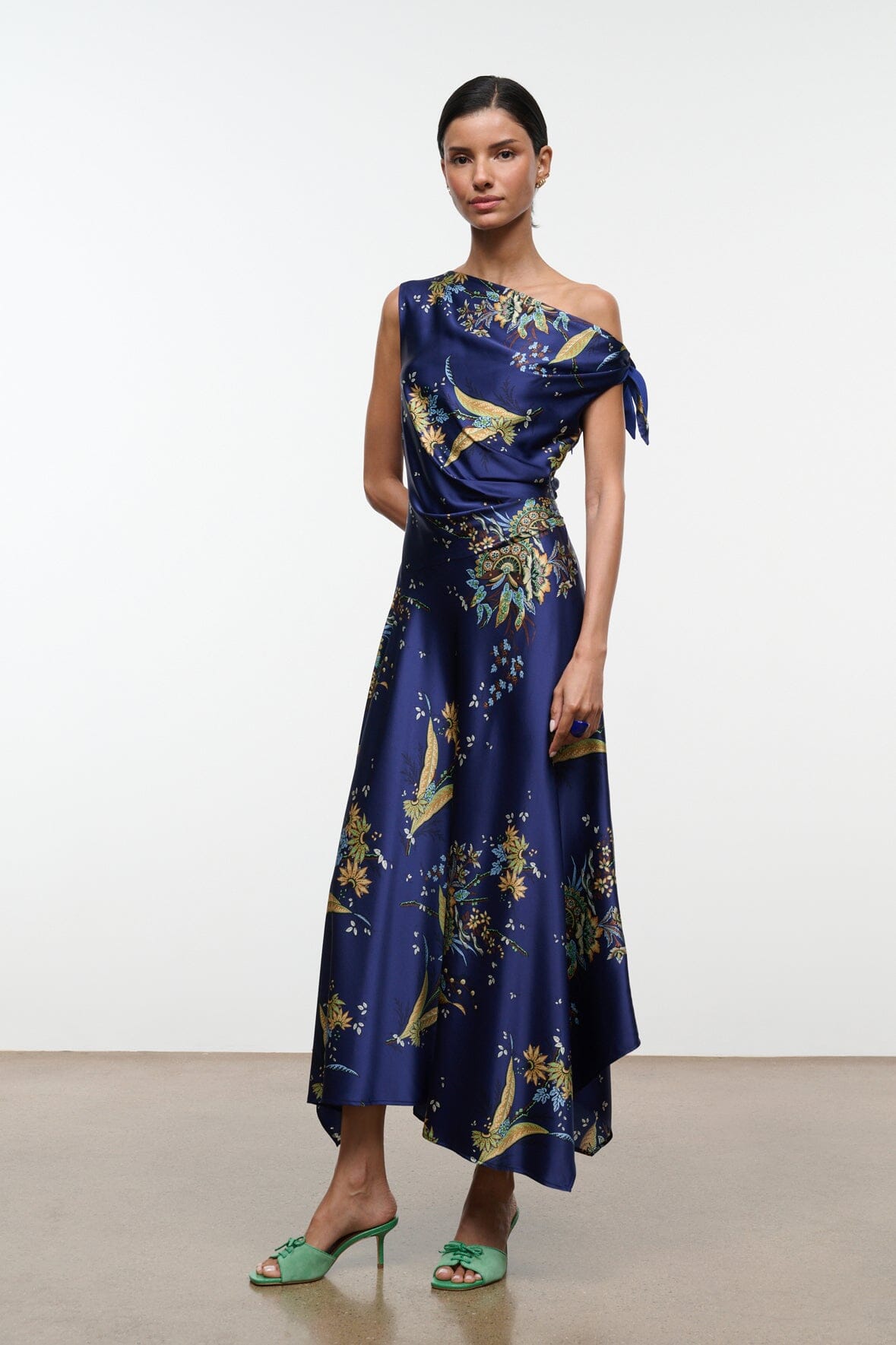 Navy silk midi dress with one-shoulder drape and gold floral tapestry print