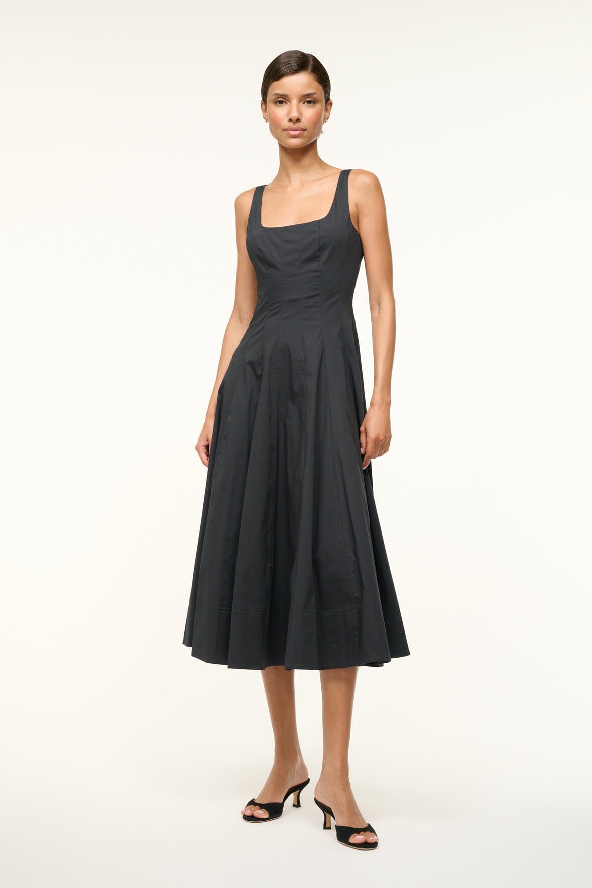 Black sleeveless midi dress with thin straps, square neckline, and pleated skirt