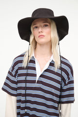 Dark brown bucket hat on model with chin strap cords and striped shirt collar