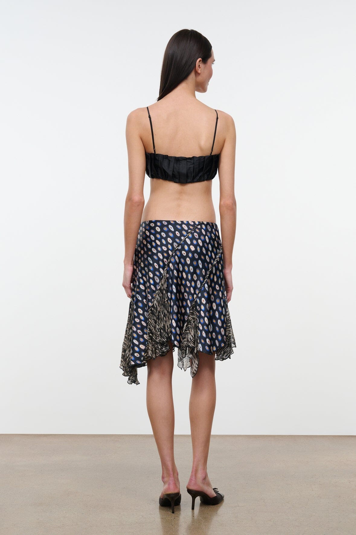 Silk skirt in navy with multicolor dot print and uneven layered hem, back view