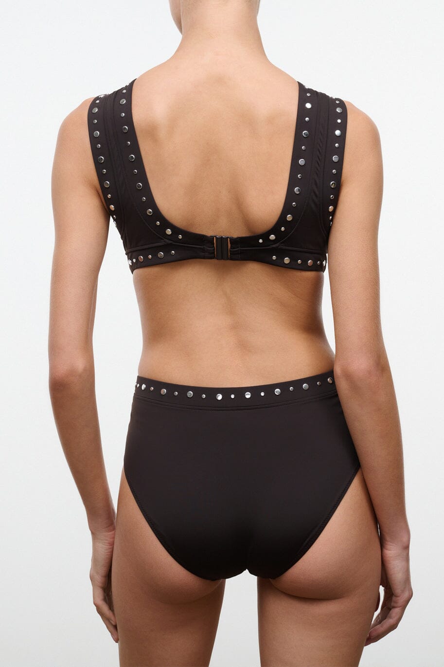 Black one-piece swimsuit back view with metal stud trim and keyhole back