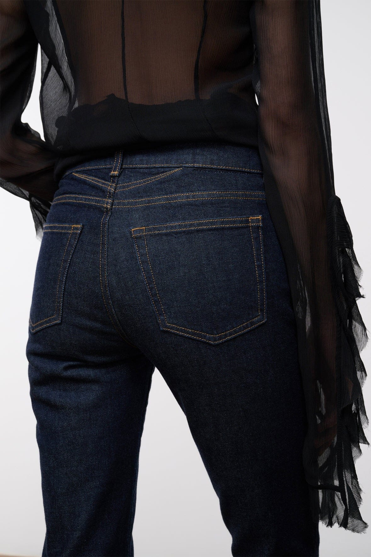 Indigo stretch flare jeans back view close-up with rear patch pocket and belt loops