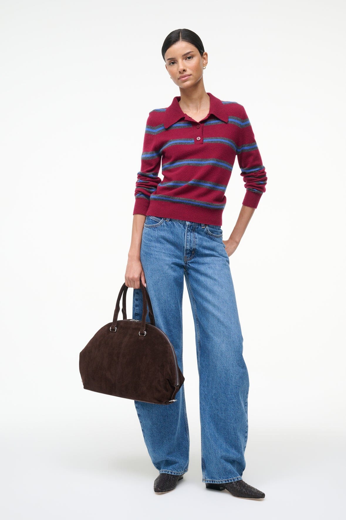 Suede satchel bag in espresso brown with top handles, shown worn