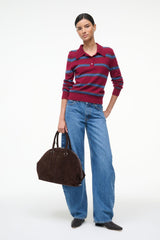 Suede satchel bag in espresso brown with top handles, shown worn