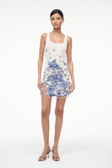 Full view of sleeveless blue toile shift dress with thin straps, square neck, tassel fringe hem
