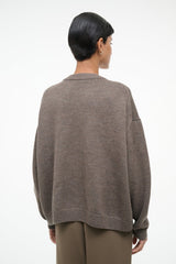 Taupe knit sweater with crew neck, ribbed cuffs, and sheep graphic on back