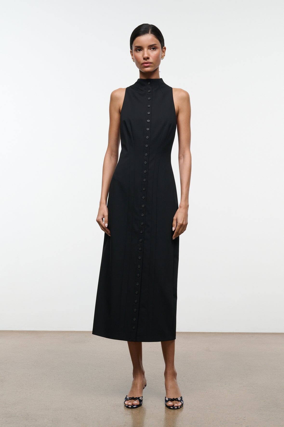 Black sleeveless midi dress with high neckline and vertical button placket