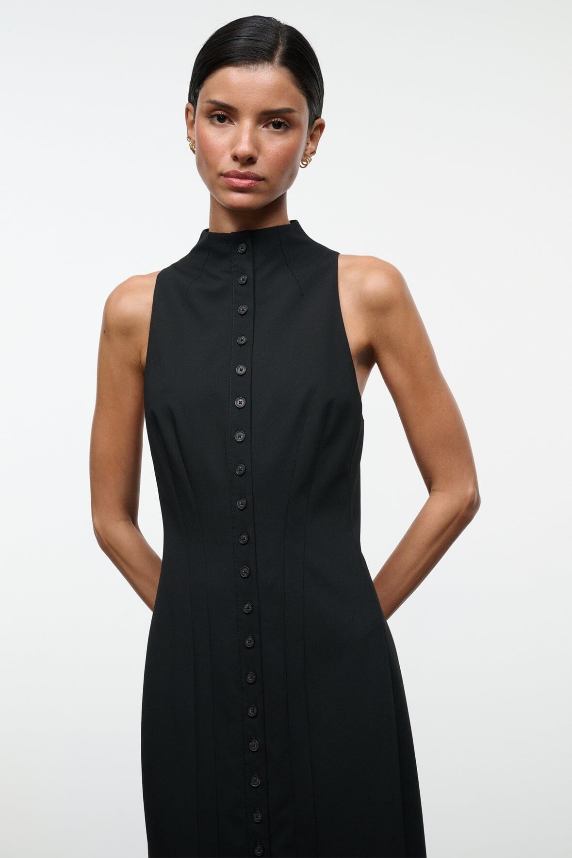 Black sleeveless high-neck dress with center button placket