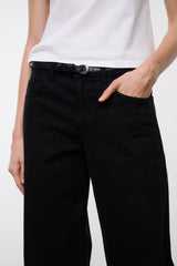 Black relaxed jeans waist close-up with belt loop, button front, and pocket detail