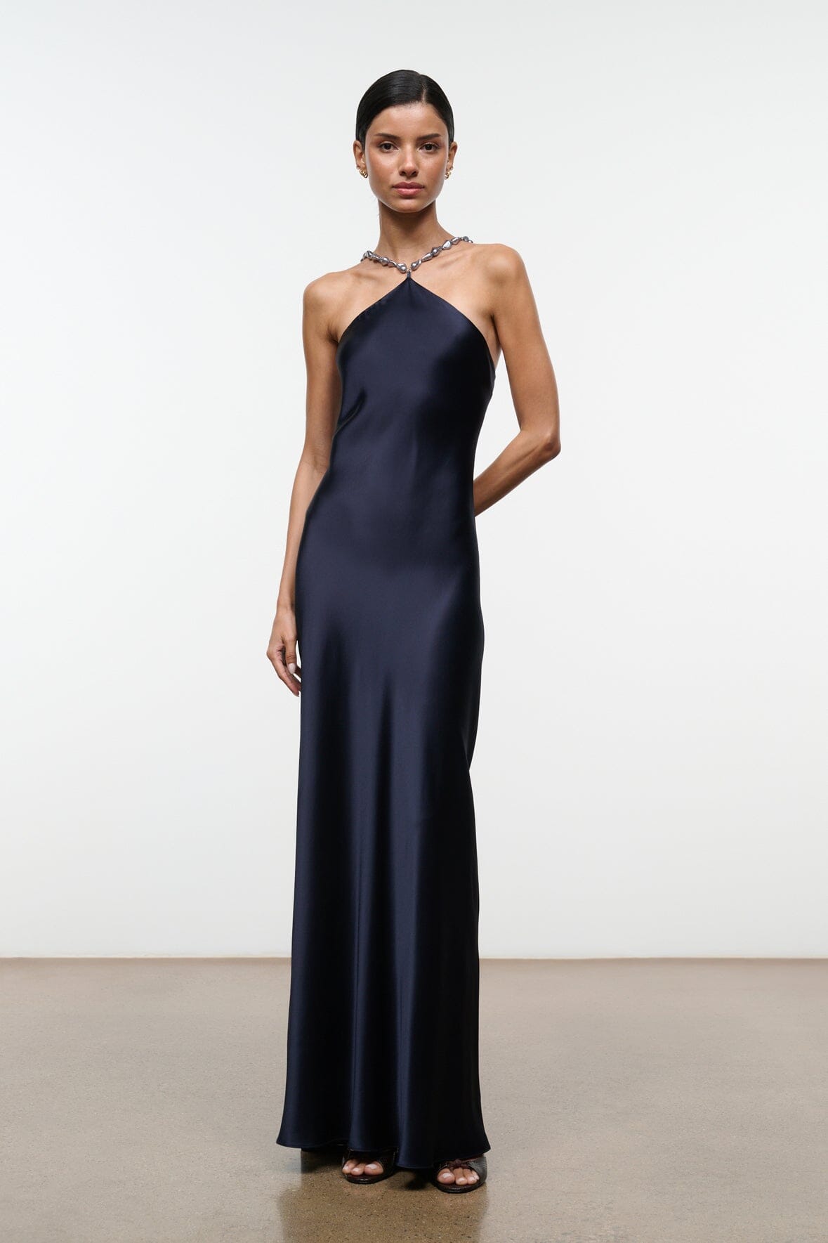 Navy halter maxi dress with beaded neckline and slim, flowing silhouette