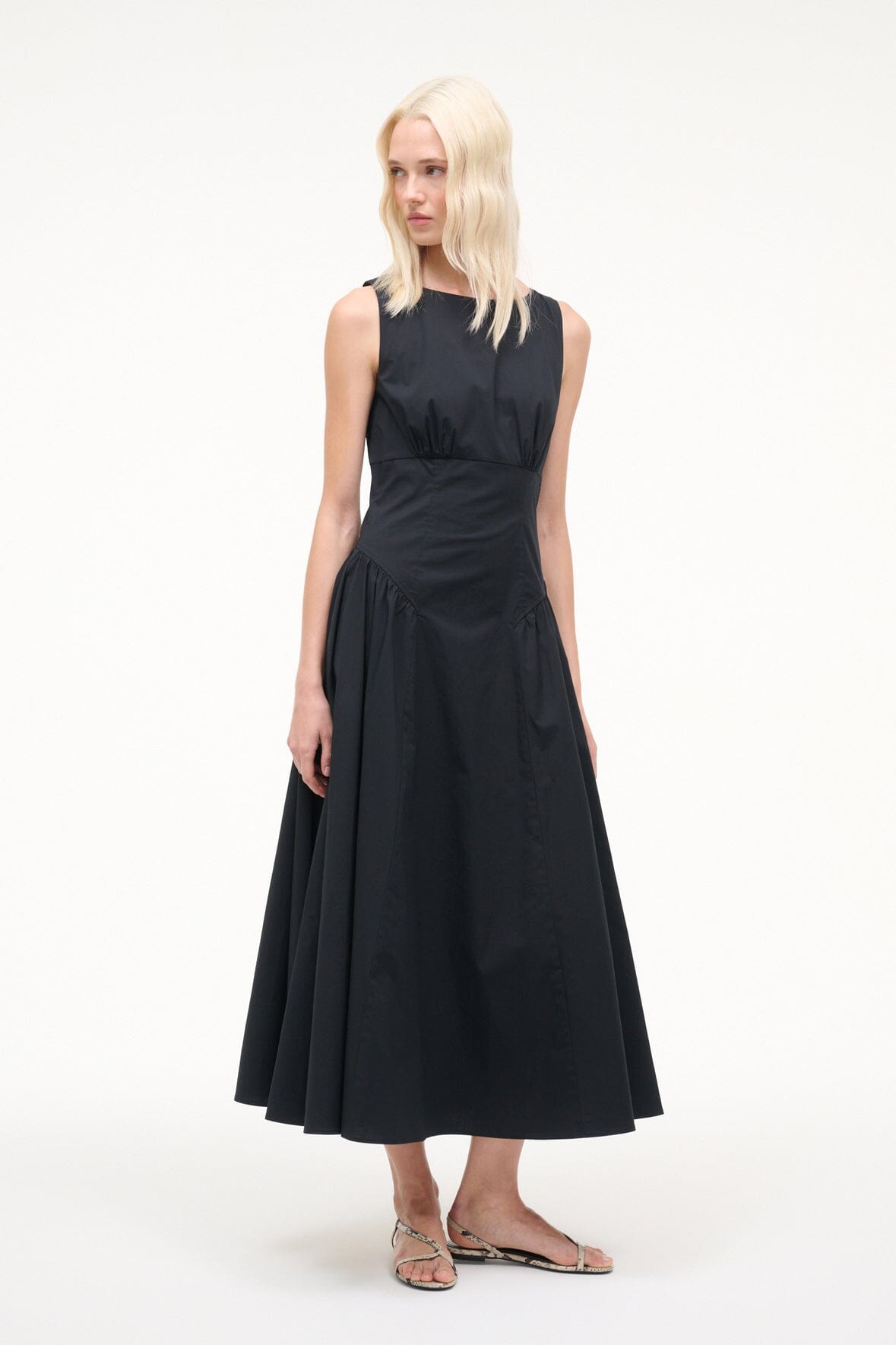 Black sleeveless midi dress with round neckline, gathered waist, flowing A-line skirt