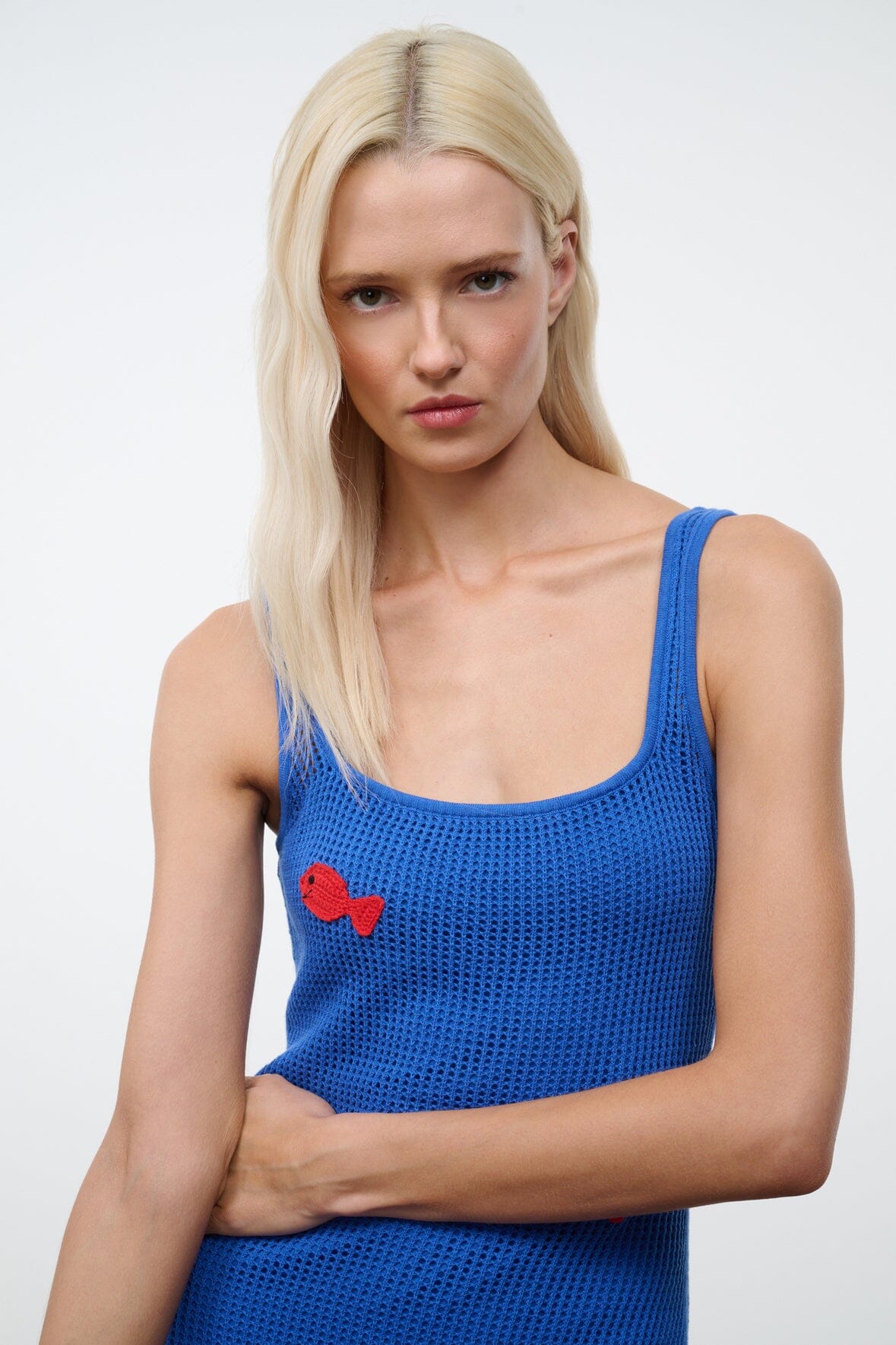 Blue knit tank dress with scoop neck and small red bow detail