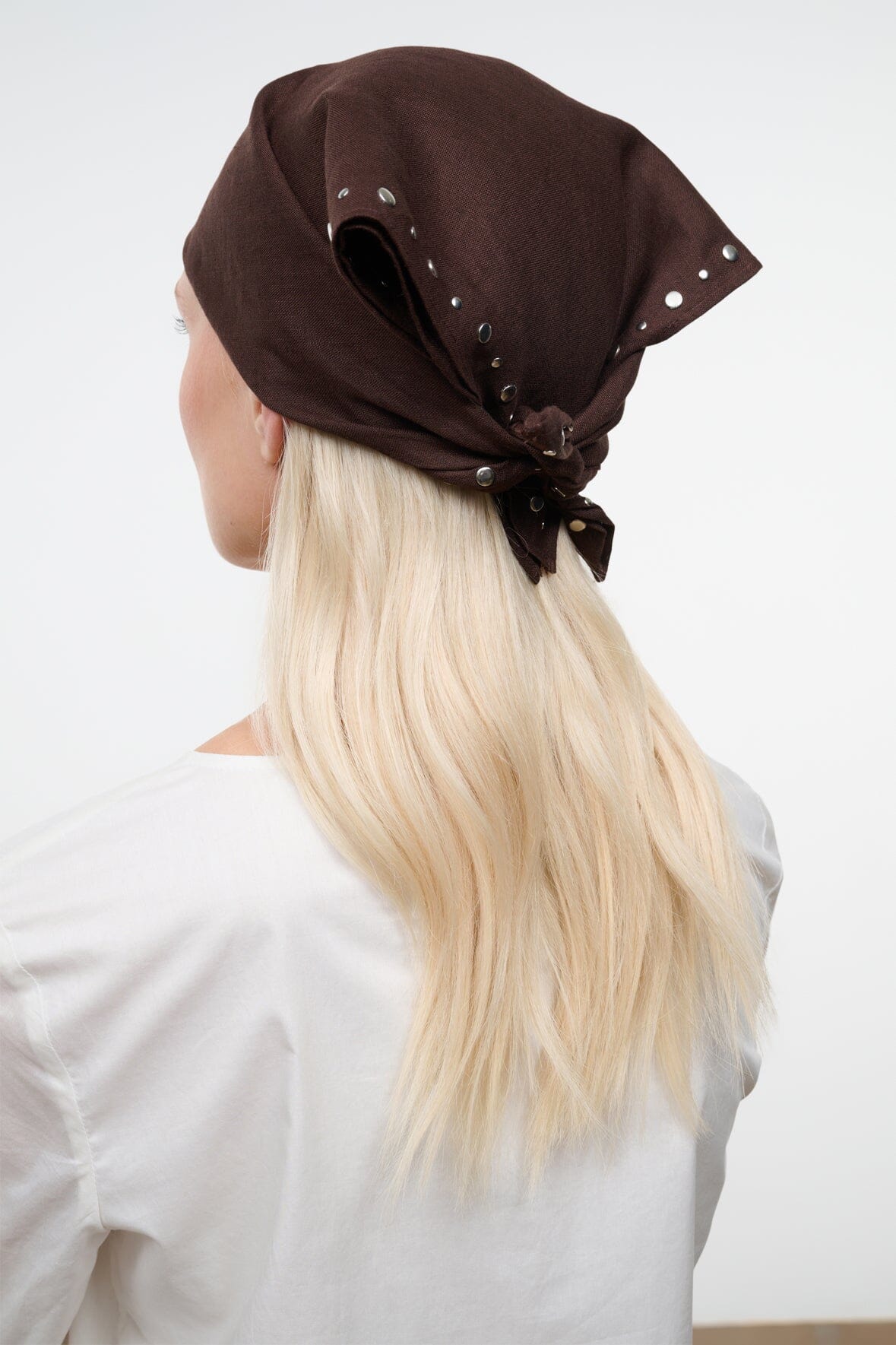 Brown headscarf with metal stud trim and bow detail, draped at crown