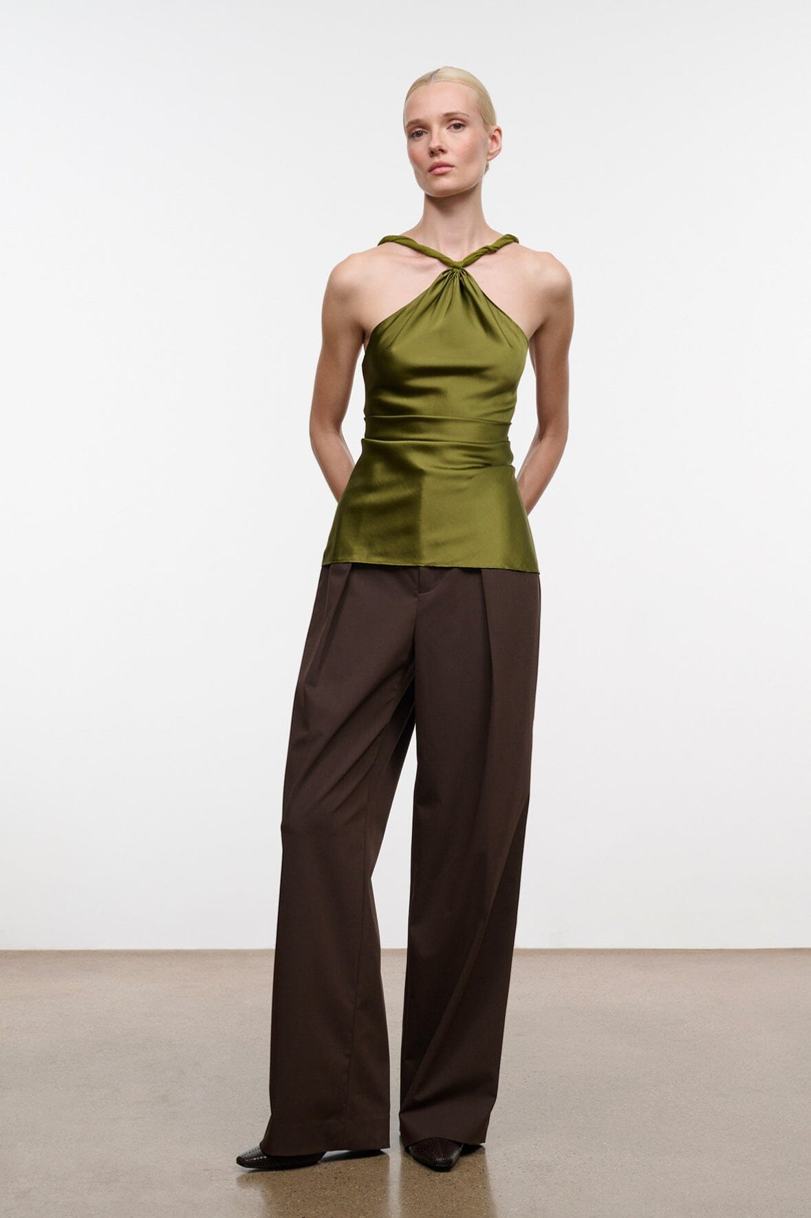 Dark brown ankle boots with snake-texture detail and wide cuff trousers