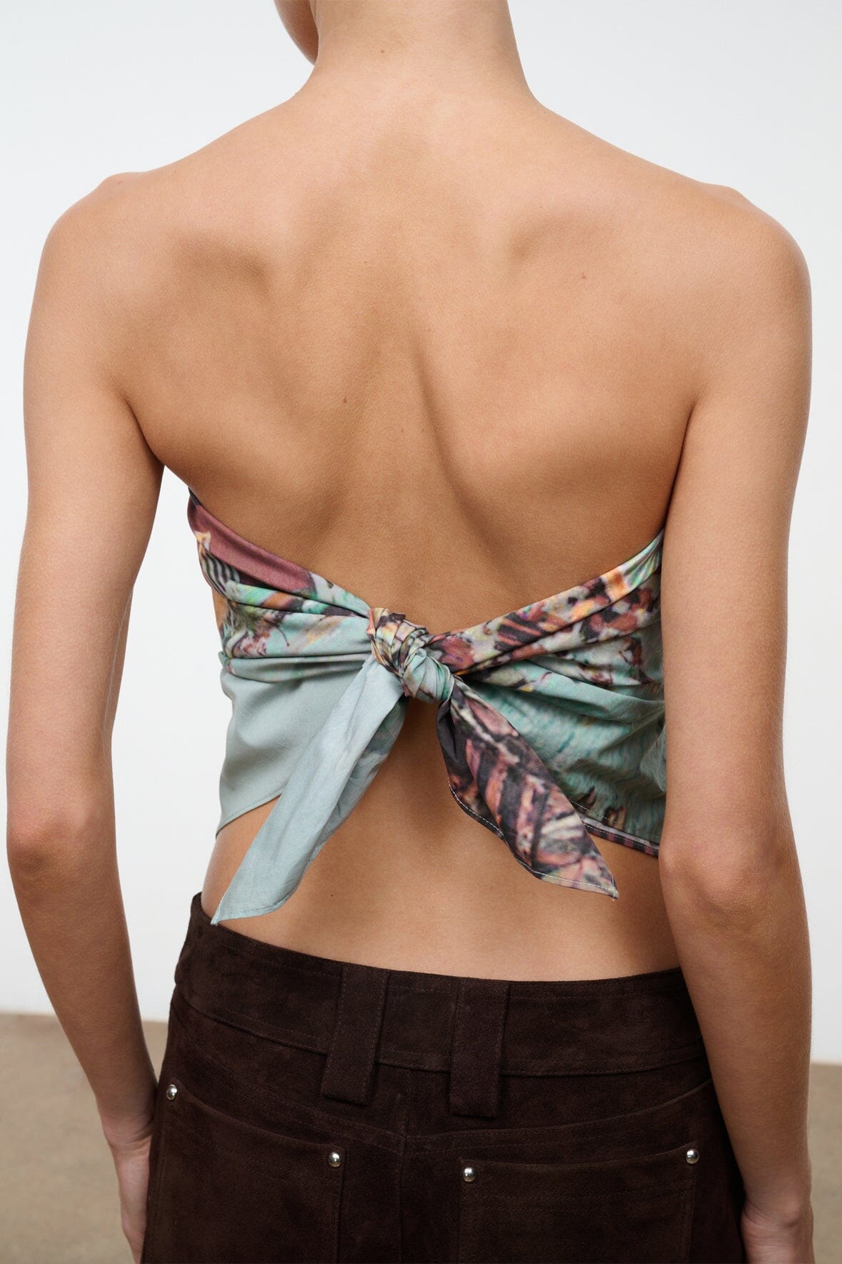 CECILE scarf worn as a backless wrap top with teal and multicolor print bow