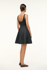 Black sleeveless mini dress back view with open scoop back and pleated skirt
