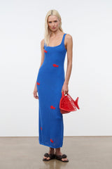 Red fish-shaped bag with handle and logo print, carried at side