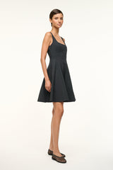 Black sleeveless mini dress with scoop neckline and pleated skirt
