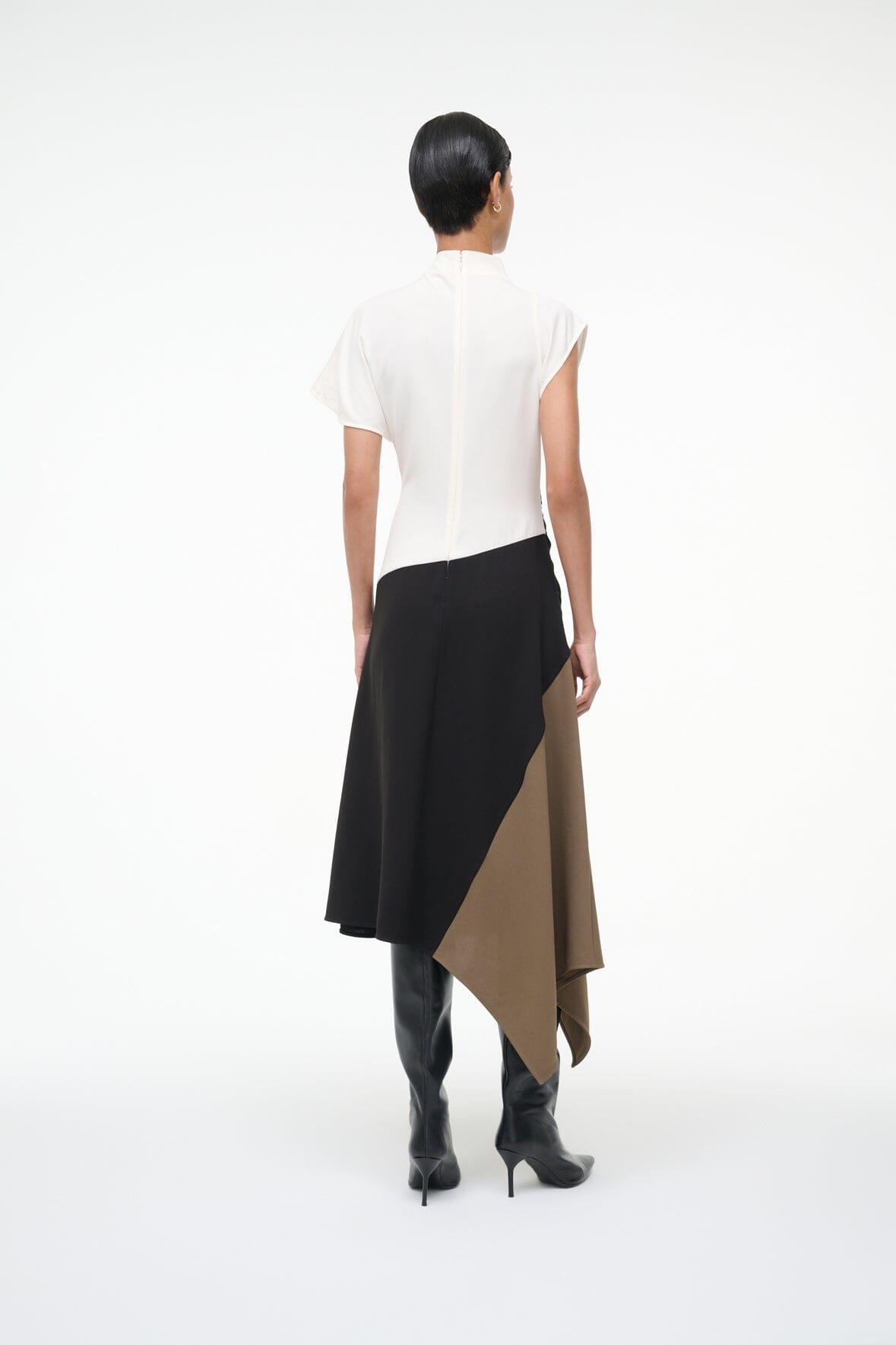 Sleeveless high-neck dress, back view, white yoke with black draped asymmetrical hem