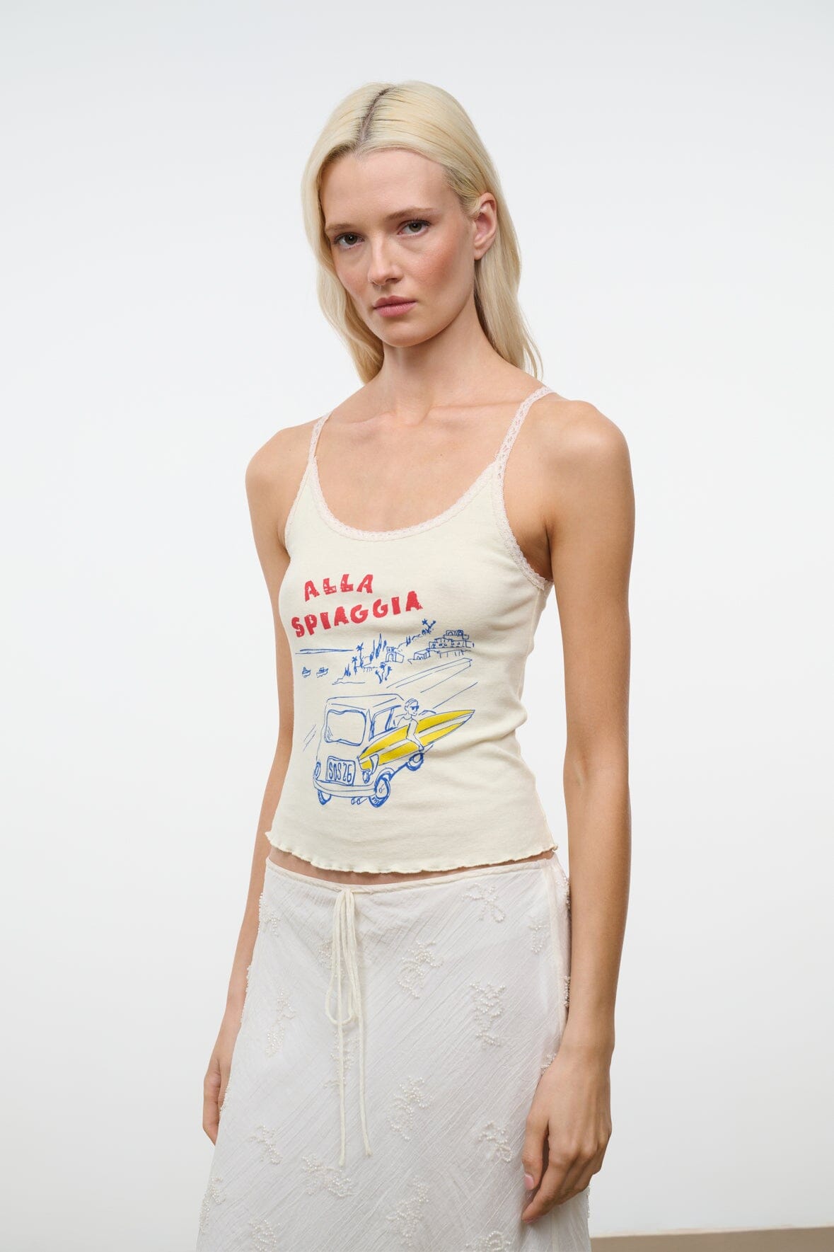 Cream sleeveless graphic camisole top with scoop neckline and thin straps